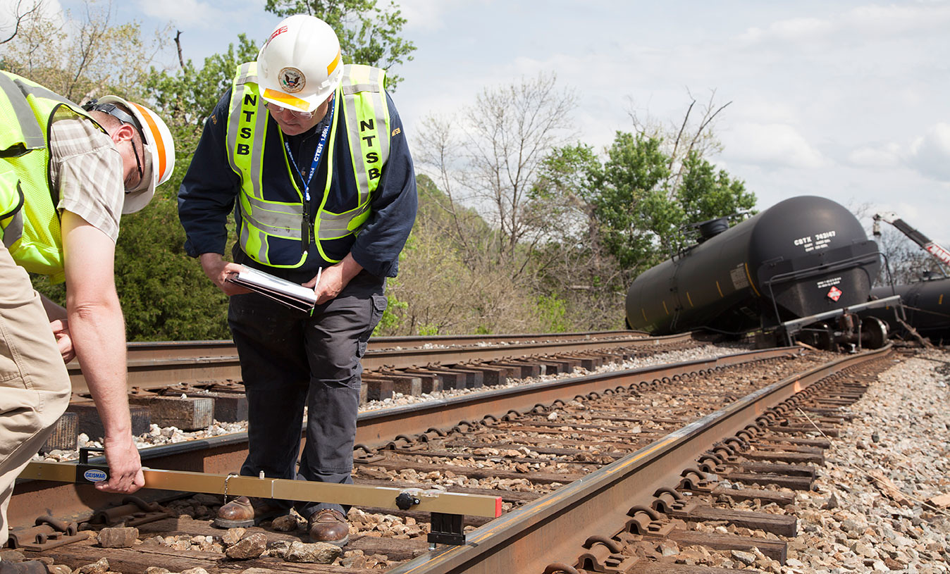 NTSB Rail Safety Investigators on scene in Lynchburg, VA NTSB rail investigator Richard Hipskind documents track damage on scene of train derailment in Lynchburg, VA. Photo by  National Transportation Safety Board