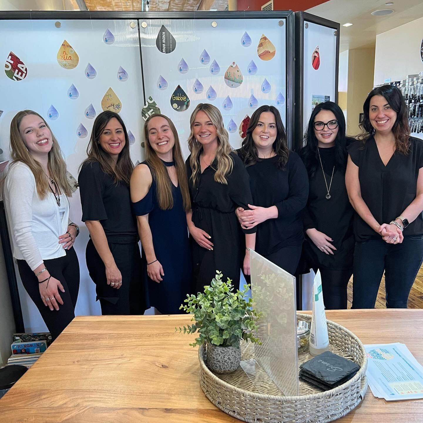 A photo of Clean Water Action's Bethany Dickerson with the staff of Serene Salon and Spa