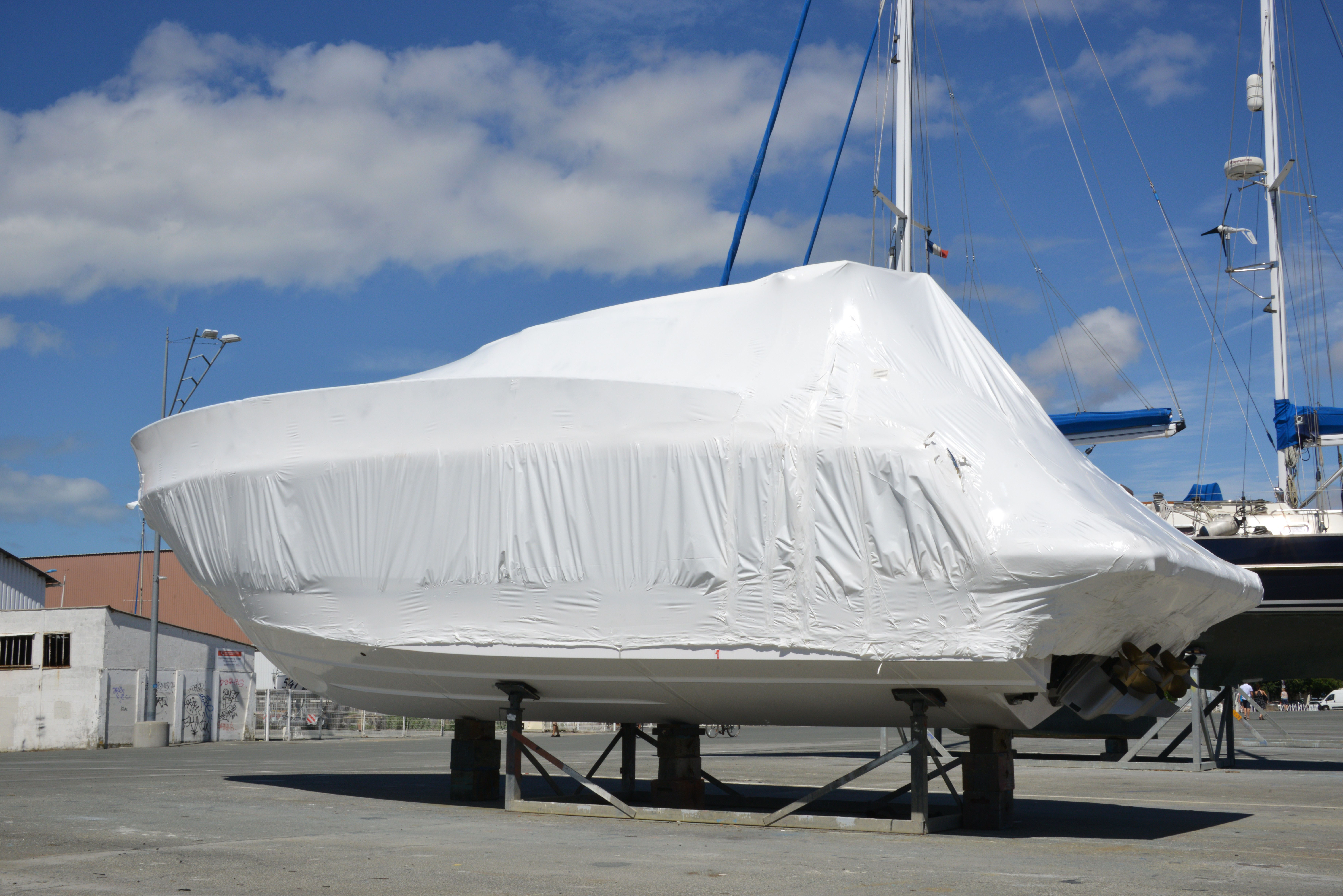 Boat wrapped in white heat shrink plastic. 