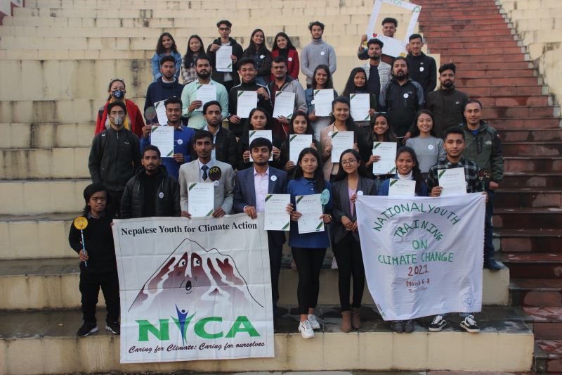 Image of Youth holding white signs: National Youth Training on Climate Change, 2021. Participants and organizers. 11th March, 2021