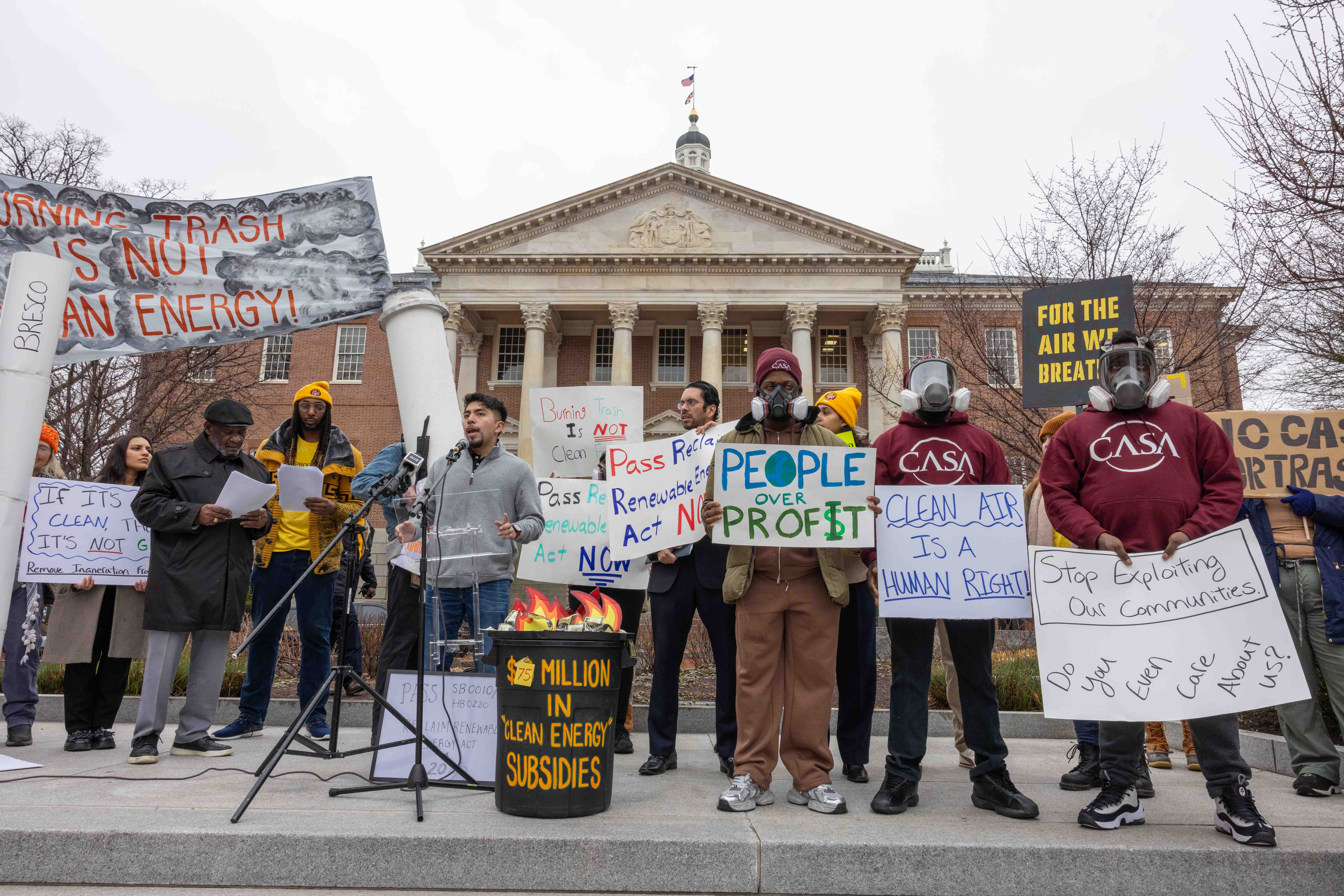 A rally in front of the State House in Annapolis with people holding signs like "Burning trash is not clean energy"