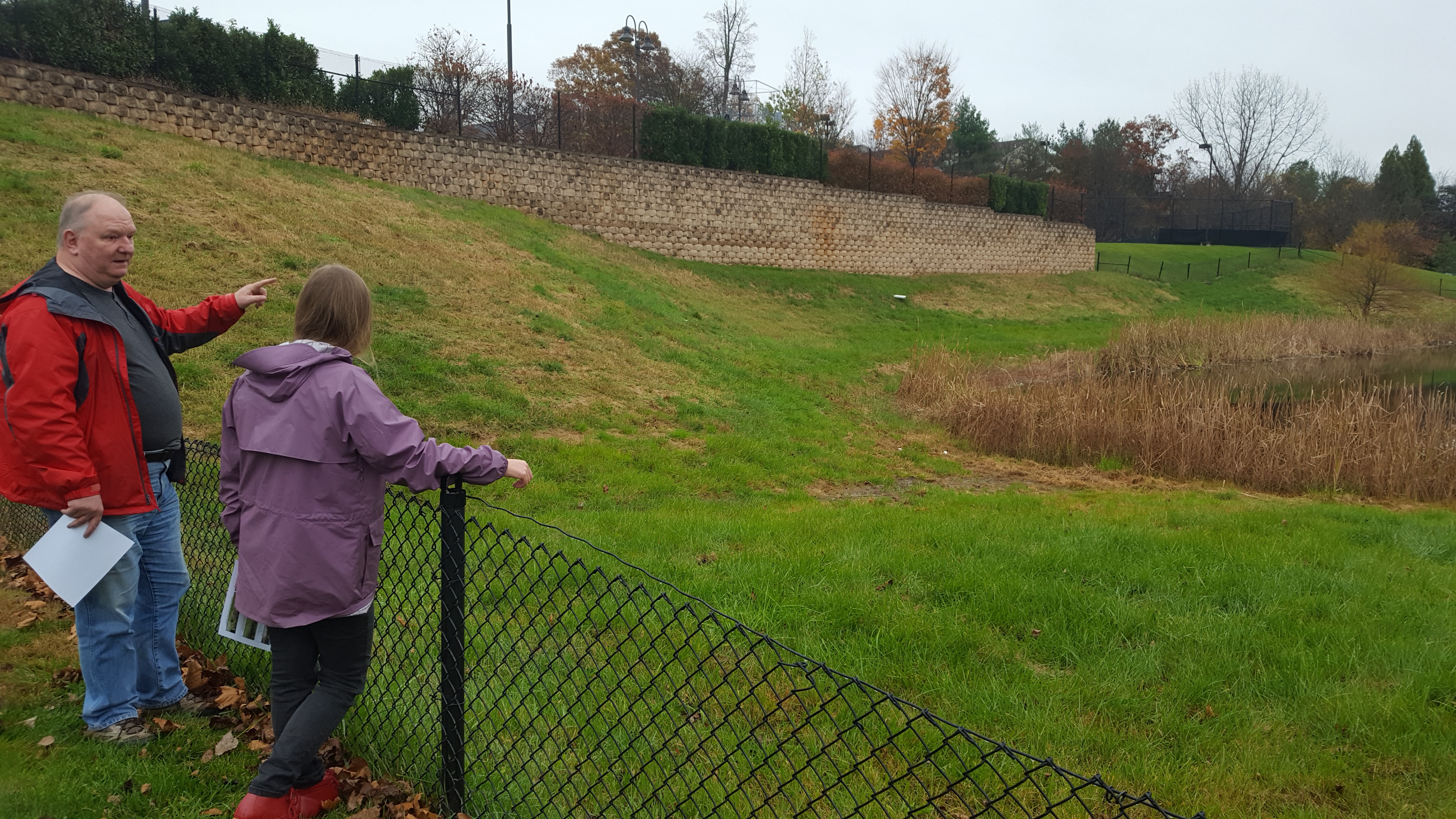 Richard and Jennifer look at a failing infiltration basin