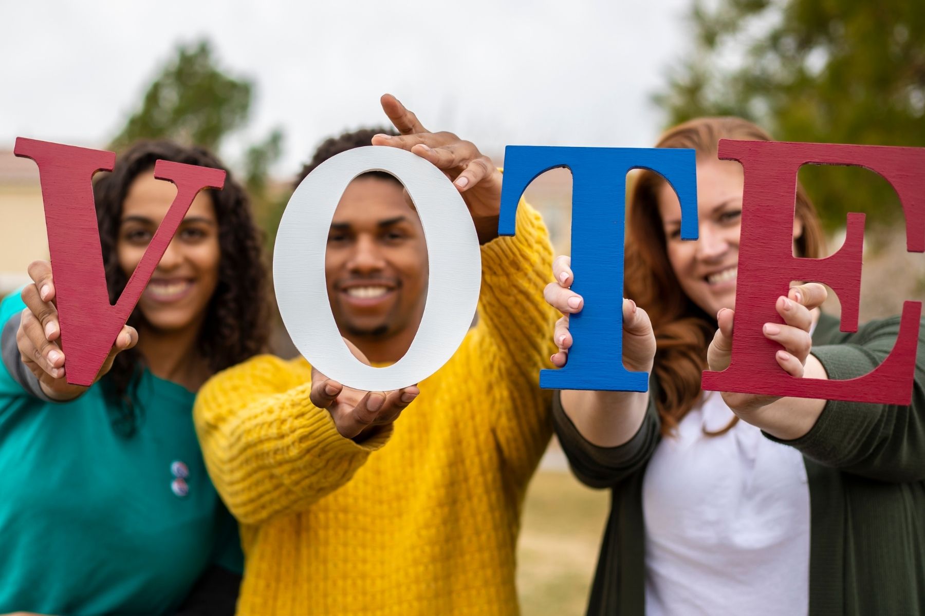 People hold letters that spell vote.