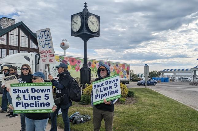 Protestors in Mackinaw City holding "Shut Down Line 5 Pipeline" signs