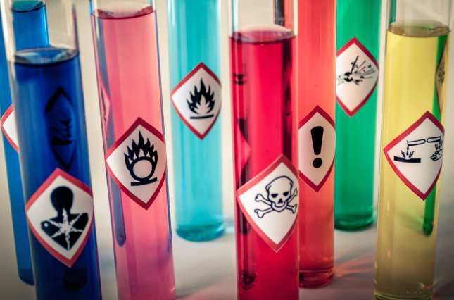 Test tubes of chemicals with warning labels