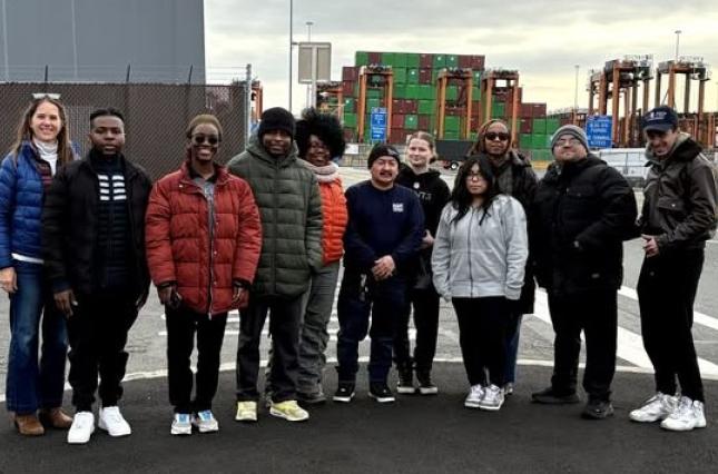 A dozen advocates standing by an industrial port in New Jersey