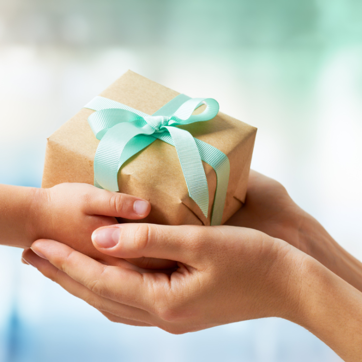 Adult and child exchange a gift