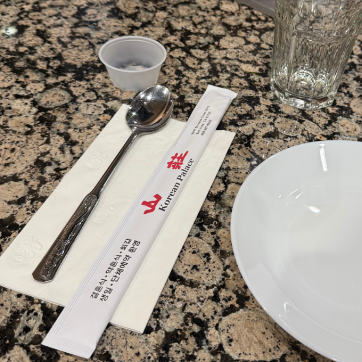 Single-use sauce cup and chopsticks, with reusable spoon, glass, and plate