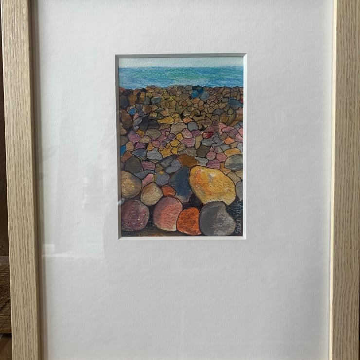 Painting of rainbow rocks along seashore by Susan Nelson
