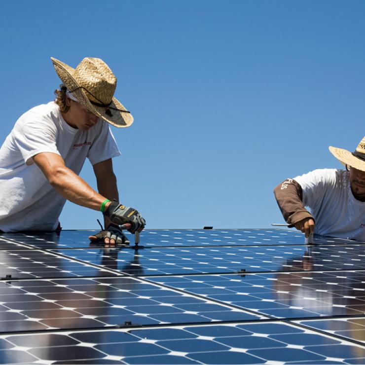 Solar workers installing panels