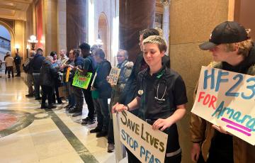 Rally outside MN legislature signs "Save lives stop PFAS" "for Amara"