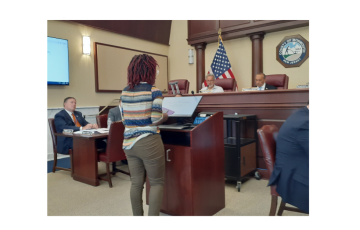 Image of Clean Water Action's Warehouse Organizer Tolani Taylor testifying in NJ