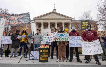 Picture of people rallying in Annapolis with signs like "Burning trash is not clean energy," "for the air we breathe," and "let's reclaim renewable energy."