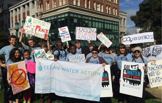Gathering for demonstration against frackign in California including Clean Water Action banner and signs "Get The Frack Out Of Here"
