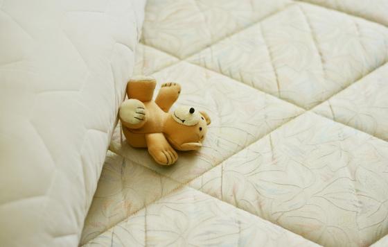 Mattress witha teddy bear on it