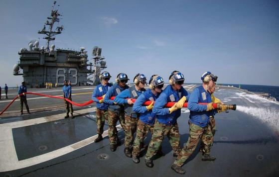 air department personnel wash aqueous film forming foam AFF off a plane